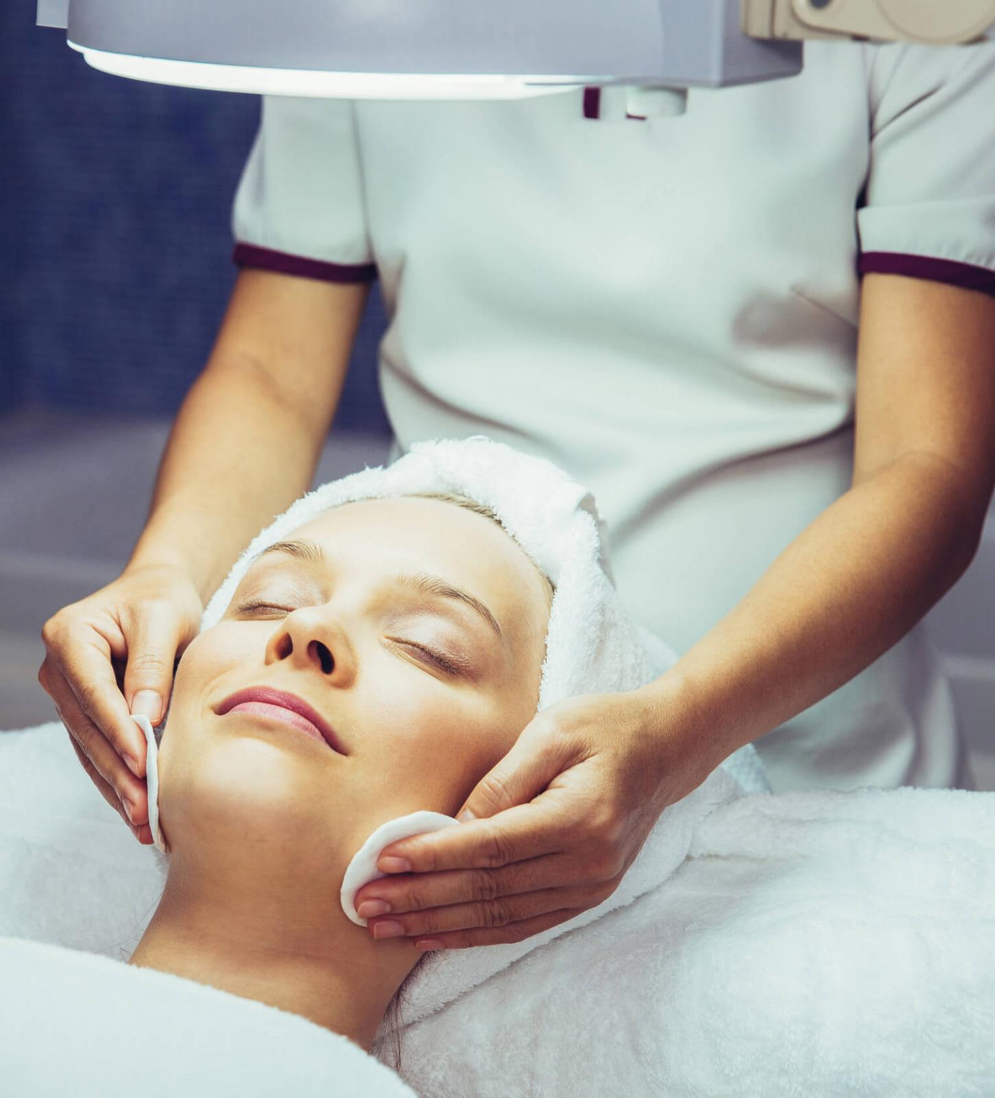 Esthetician performing a facial skin treatment